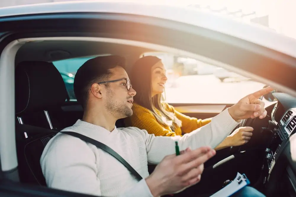 Woman In Car With Driving Instructor